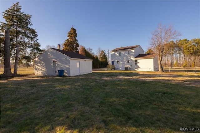 view of yard featuring an outbuilding and fence