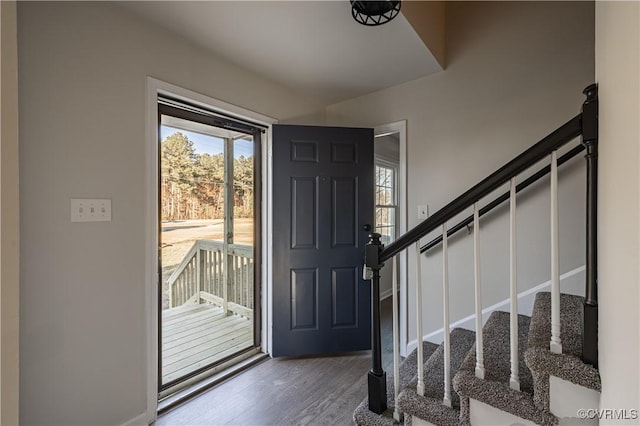 foyer featuring stairway and wood finished floors