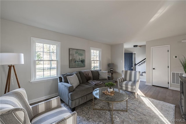 living area featuring stairs, dark wood finished floors, visible vents, and baseboards