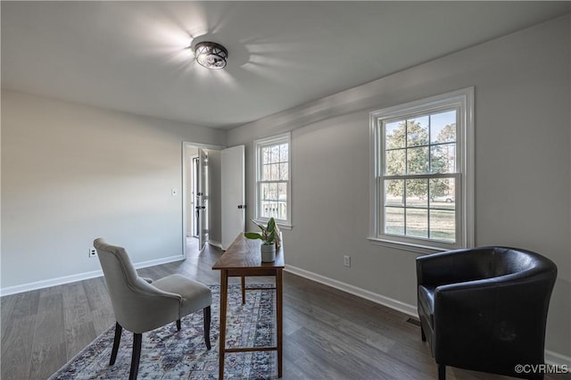 home office with dark wood-style flooring and baseboards