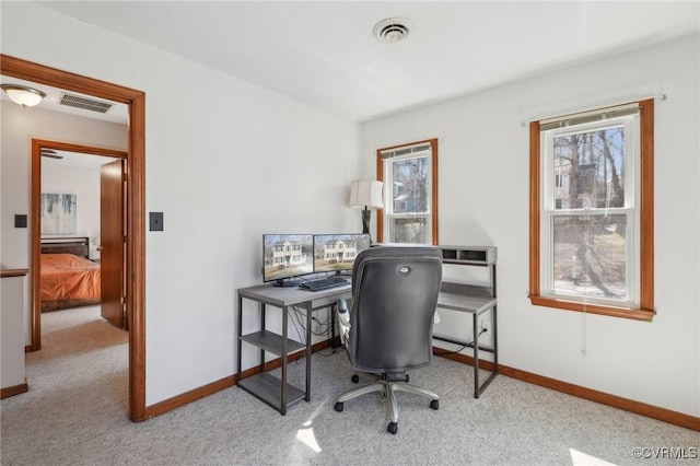 carpeted office with visible vents and baseboards