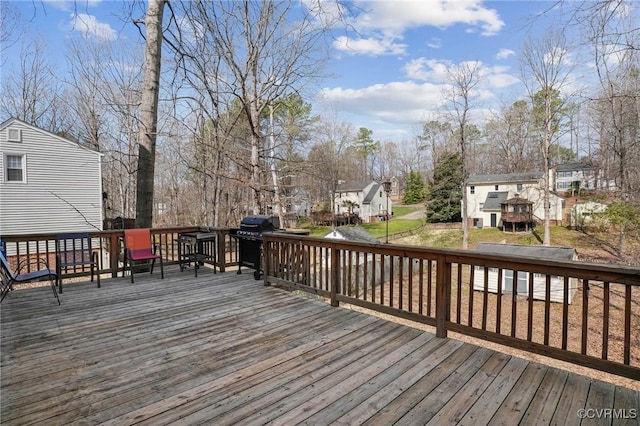 wooden deck with a residential view and a lawn