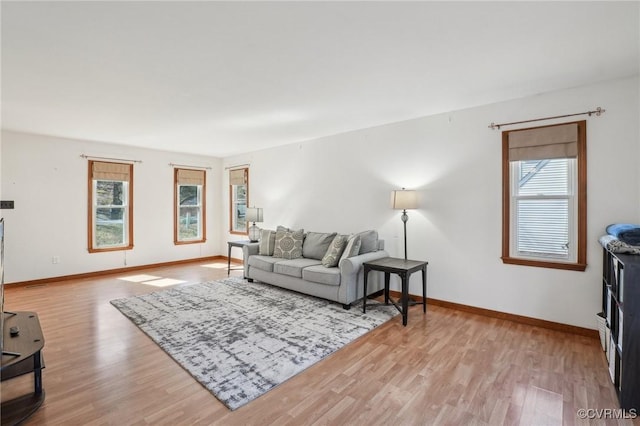 living room featuring baseboards and light wood-style floors