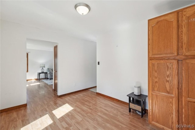 unfurnished room featuring light wood-style floors and baseboards