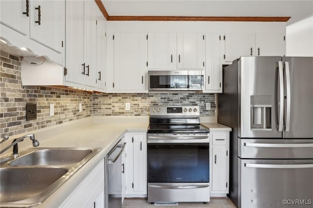 kitchen featuring stainless steel appliances, a sink, and white cabinetry