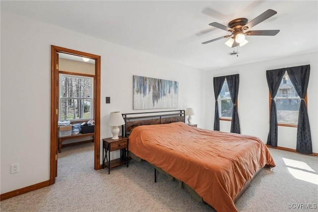 bedroom featuring light carpet, ceiling fan, and baseboards