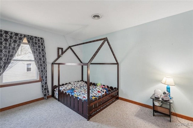 carpeted bedroom with visible vents and baseboards