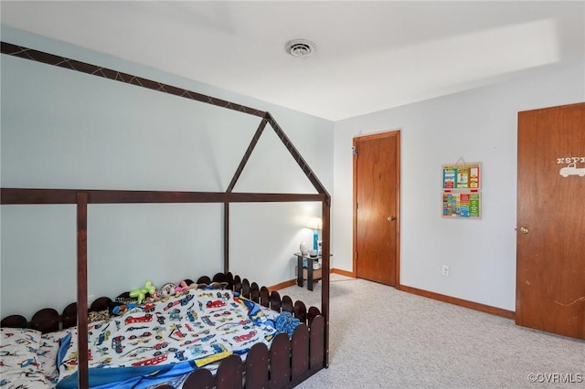 carpeted bedroom featuring baseboards and visible vents