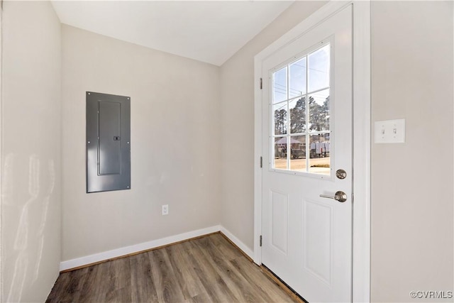 doorway to outside with electric panel, baseboards, and wood finished floors