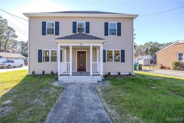 view of front of property featuring a front lawn and a porch