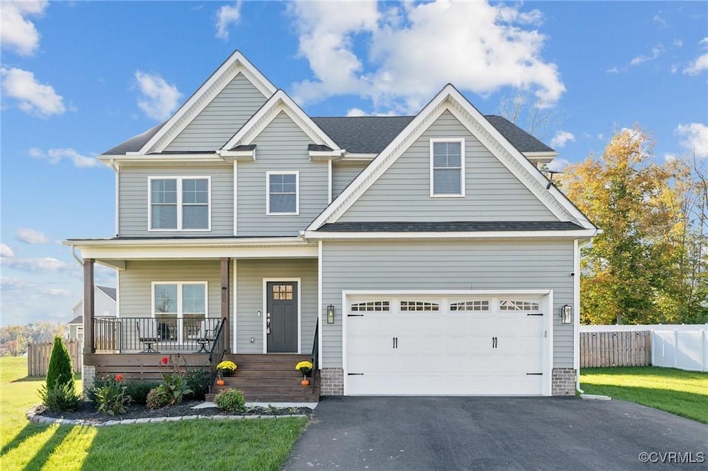 206 Eliza Ln, Aylett, VA 23009 - craftsman house featuring aphalt driveway, covered porch, a garage, fence, and a front lawn
