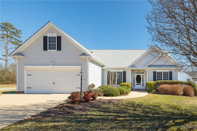 view of front facade with a garage, driveway, and a front lawn