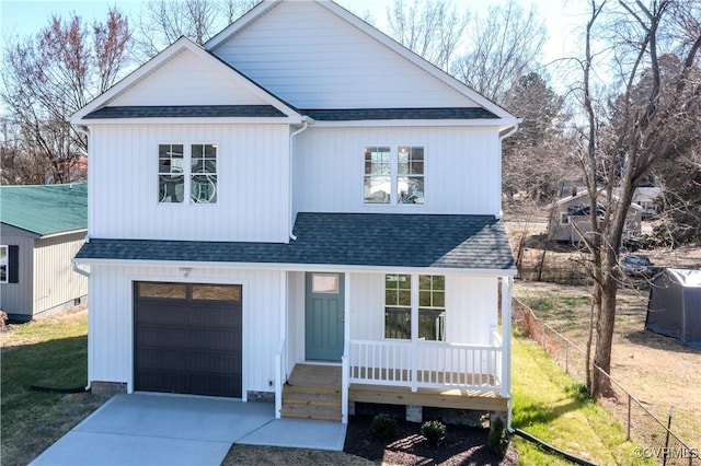 modern farmhouse with roof with shingles, a porch, concrete driveway, an attached garage, and fence