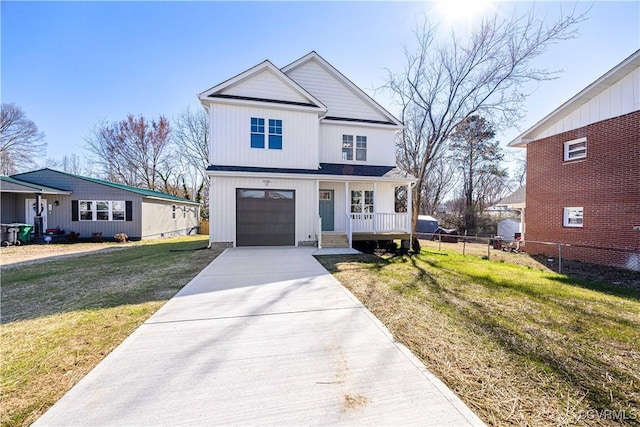 view of front of home featuring a porch, fence, a garage, driveway, and a front lawn