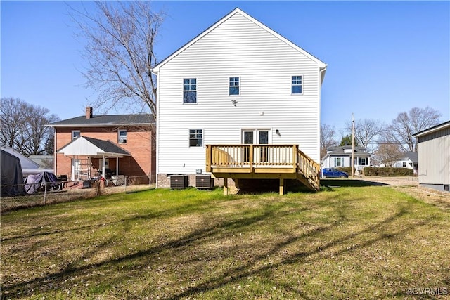 back of house featuring central AC unit, fence, a lawn, and a wooden deck