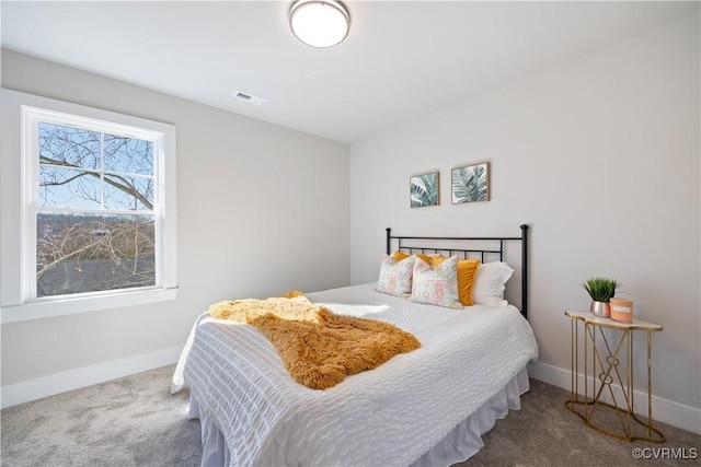 bedroom featuring carpet floors, visible vents, and baseboards