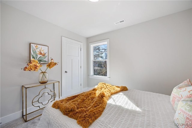 bedroom with carpet, visible vents, and baseboards