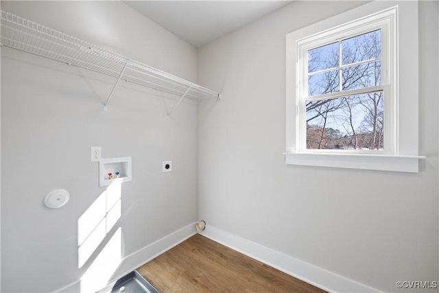 laundry area featuring hookup for a washing machine, hookup for an electric dryer, wood finished floors, laundry area, and baseboards