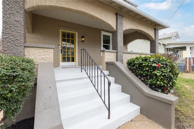 property entrance with stucco siding