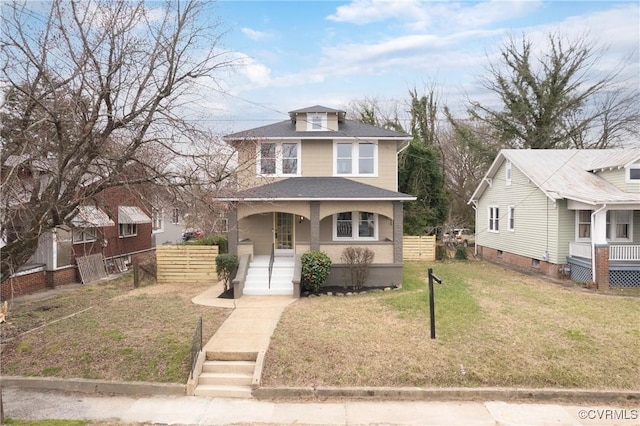 traditional style home with a porch, fence, a front lawn, and a shingled roof