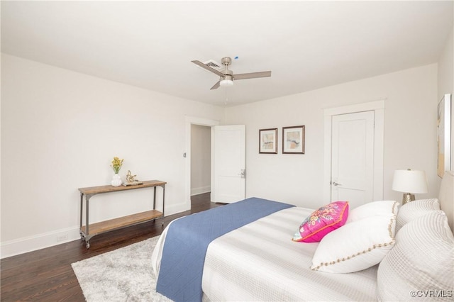 bedroom with ceiling fan, baseboards, and dark wood-style floors