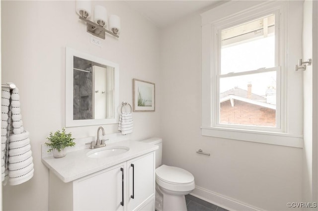 bathroom with vanity, baseboards, walk in shower, tile patterned floors, and toilet