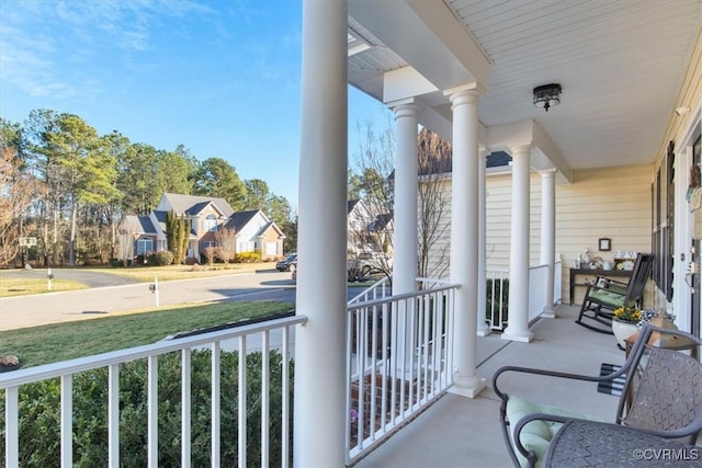 balcony featuring covered porch and a residential view