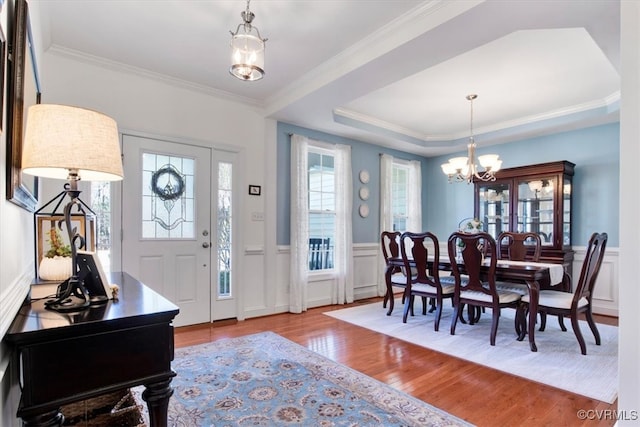 foyer entrance featuring a wainscoted wall, a notable chandelier, and wood finished floors