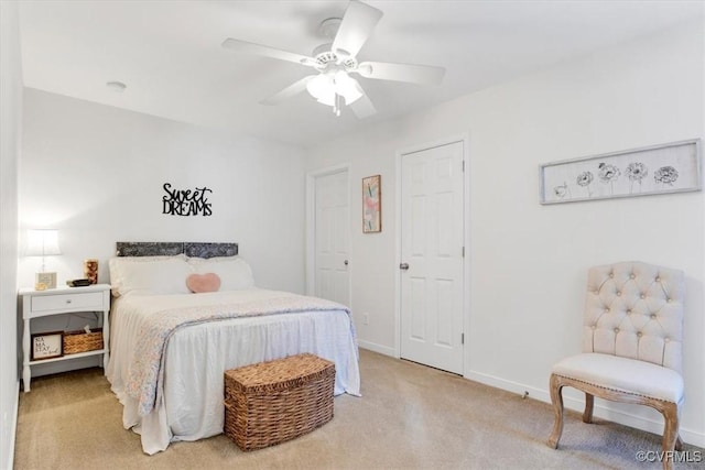 bedroom featuring baseboards, ceiling fan, and light colored carpet