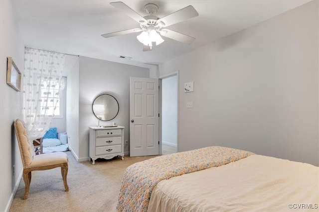 bedroom with a ceiling fan, light colored carpet, visible vents, and baseboards