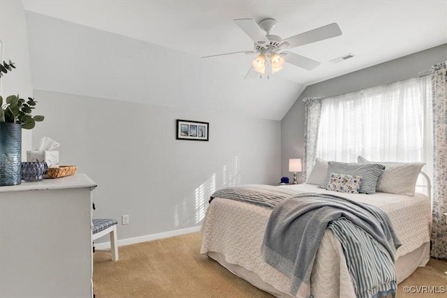 bedroom with lofted ceiling, light colored carpet, visible vents, a ceiling fan, and baseboards