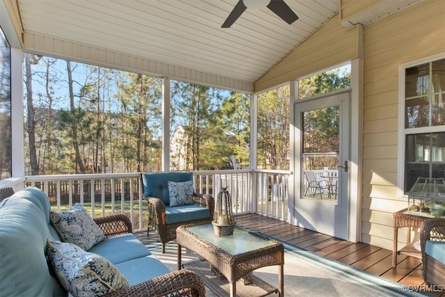 sunroom with lofted ceiling and ceiling fan