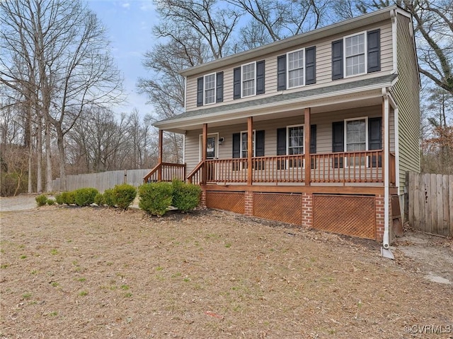 view of front of property featuring covered porch and fence