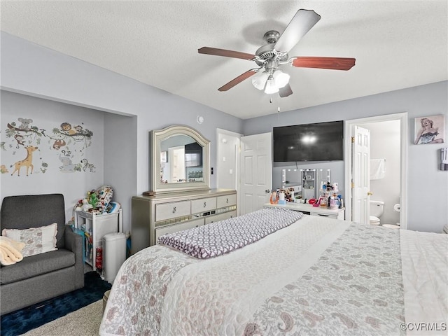 bedroom featuring ceiling fan, a textured ceiling, and ensuite bathroom