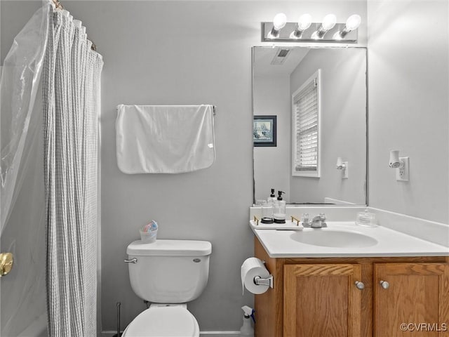 bathroom featuring visible vents, a shower with shower curtain, vanity, and toilet