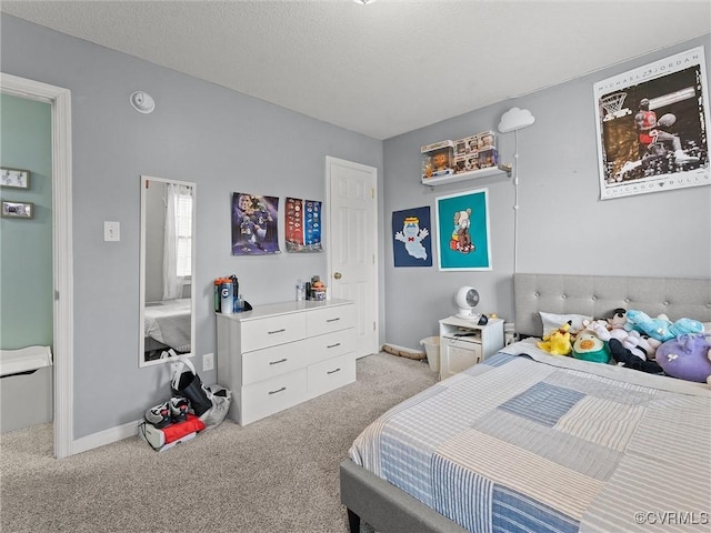 bedroom featuring a textured ceiling, baseboards, and carpet flooring