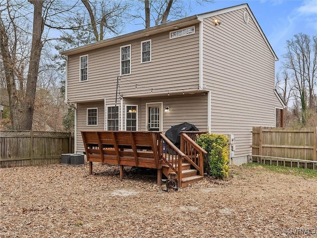 back of house featuring fence and a deck