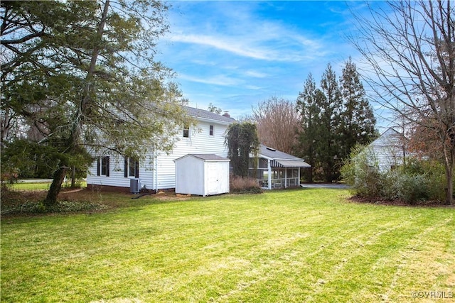 view of yard featuring an outbuilding, a shed, and cooling unit