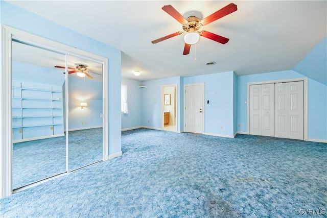 interior space featuring baseboards, two closets, and carpet flooring