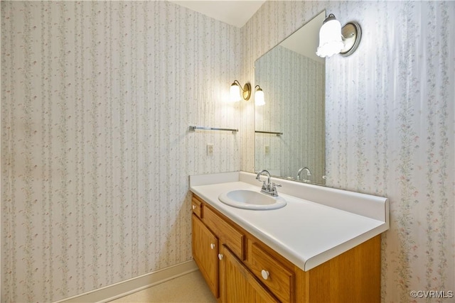 bathroom featuring wallpapered walls and vanity