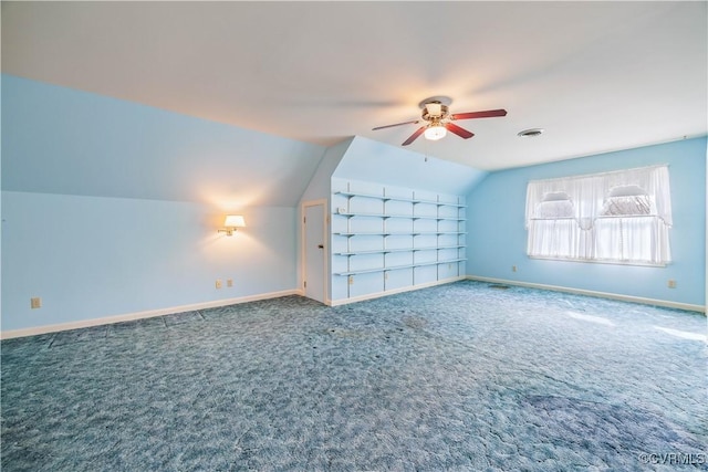 additional living space featuring visible vents, lofted ceiling, carpet floors, baseboards, and ceiling fan