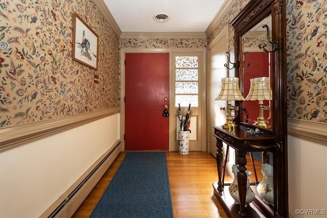 interior space with wallpapered walls, visible vents, wainscoting, baseboard heating, and crown molding