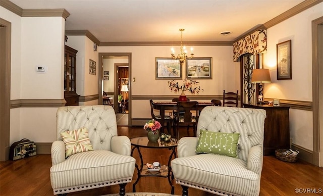 sitting room with an inviting chandelier, crown molding, visible vents, and wood finished floors