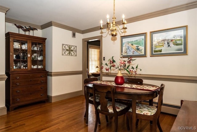 dining room with baseboards, an inviting chandelier, wood finished floors, and crown molding