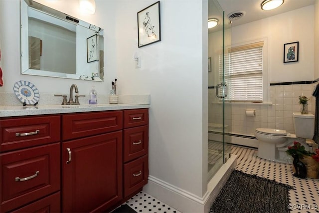 bathroom with toilet, visible vents, tile walls, baseboard heating, and a stall shower