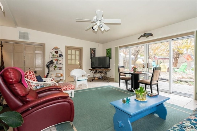 living room featuring visible vents, ceiling fan, and tile patterned floors