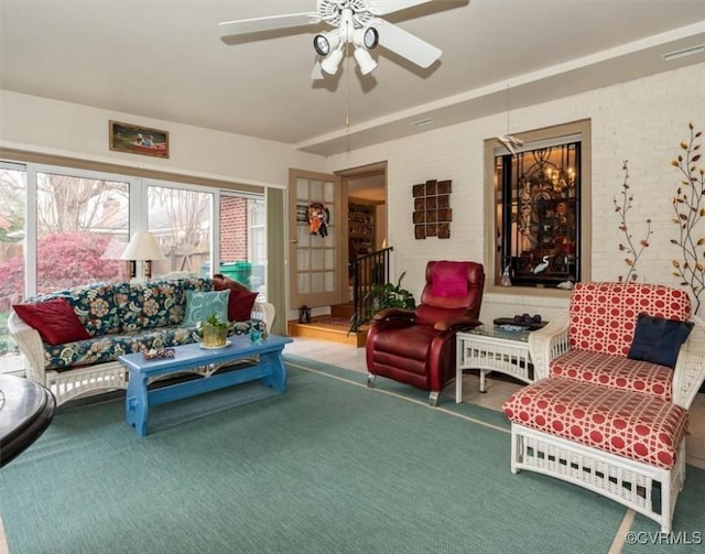 carpeted living room with visible vents and a ceiling fan