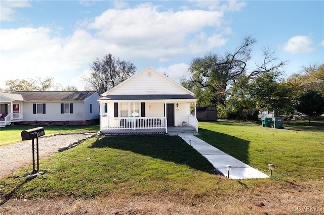 bungalow featuring covered porch and a front lawn