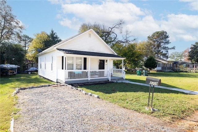 bungalow featuring a porch and a front lawn