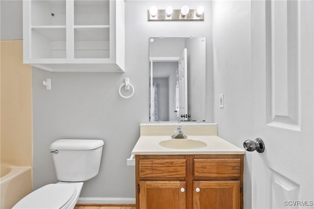 full bath with a bathing tub, vanity, and toilet